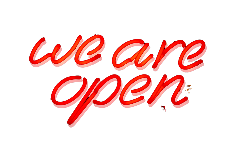 neon sign that says "we are open" in red cursive text